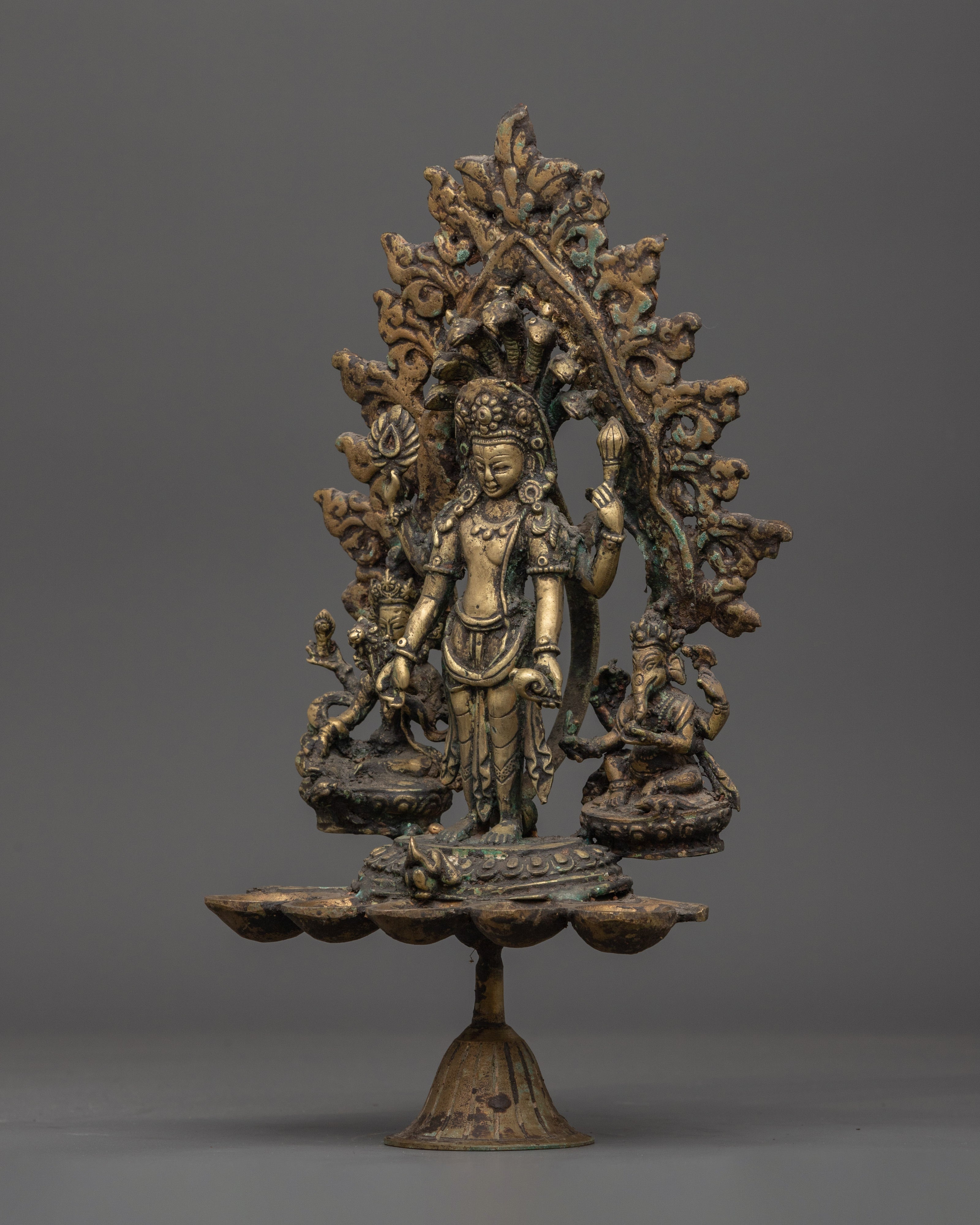Brass Oil Lamp - Decorated with Avalokiteshvara, Vasudhara & Ganesh