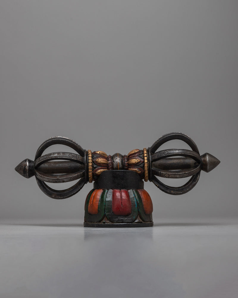  The Tibetan Vajra on Wooden Stand is a stunning combination of traditional workmanship and artistic flair, precisely crafted from iron and painted with acrylic.