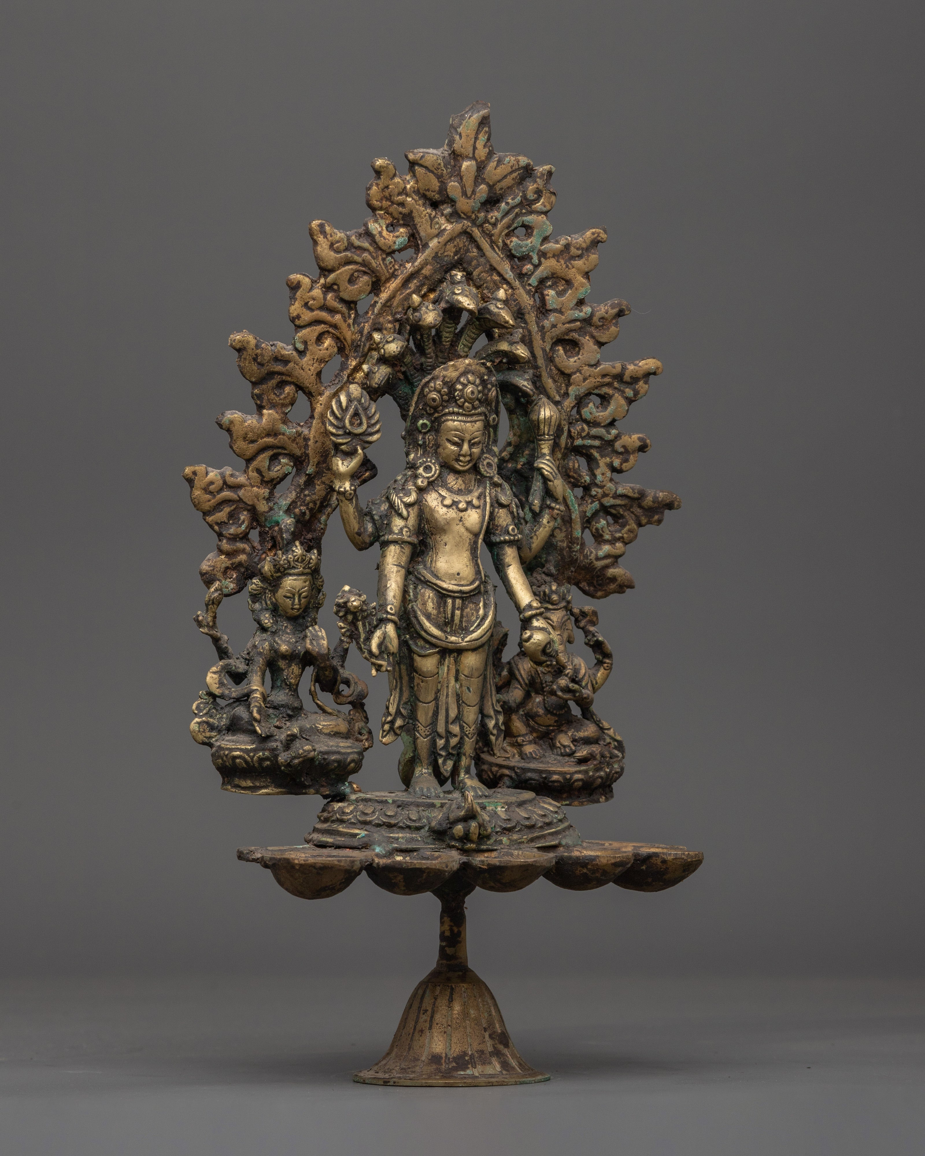Brass Oil Lamp - Decorated with Avalokiteshvara, Vasudhara & Ganesh